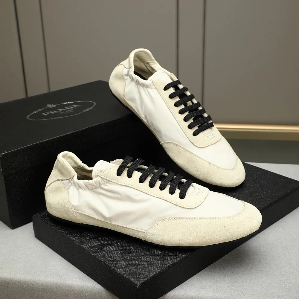 Top-down angle highlighting white Re-Nylon and suede texture on Prada sneakers