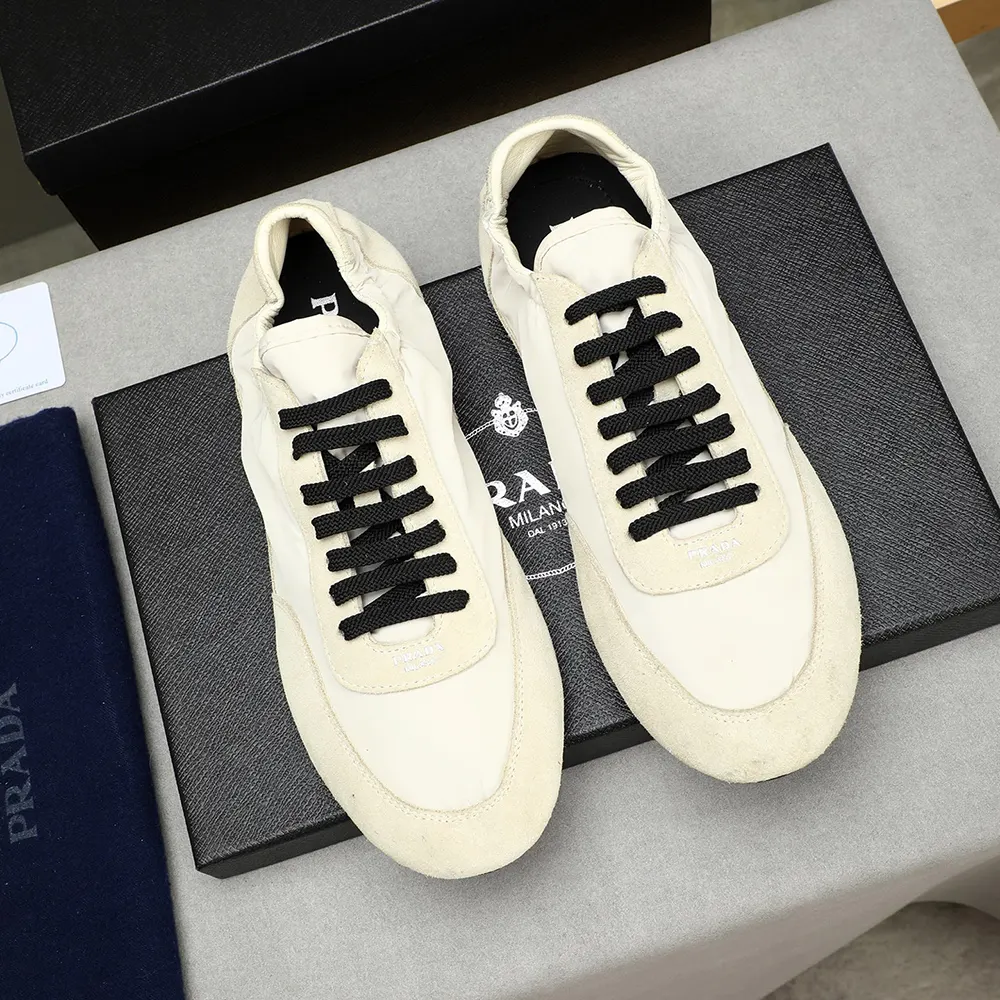 Close-up on elasticized closure and suede detail of Prada sneakers in ivory