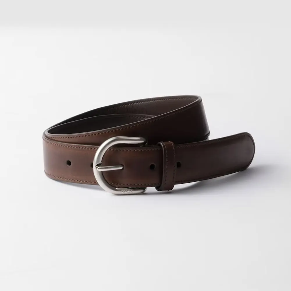 Close-up of Prada Women Antiqued Leather Belt gold buckle detail