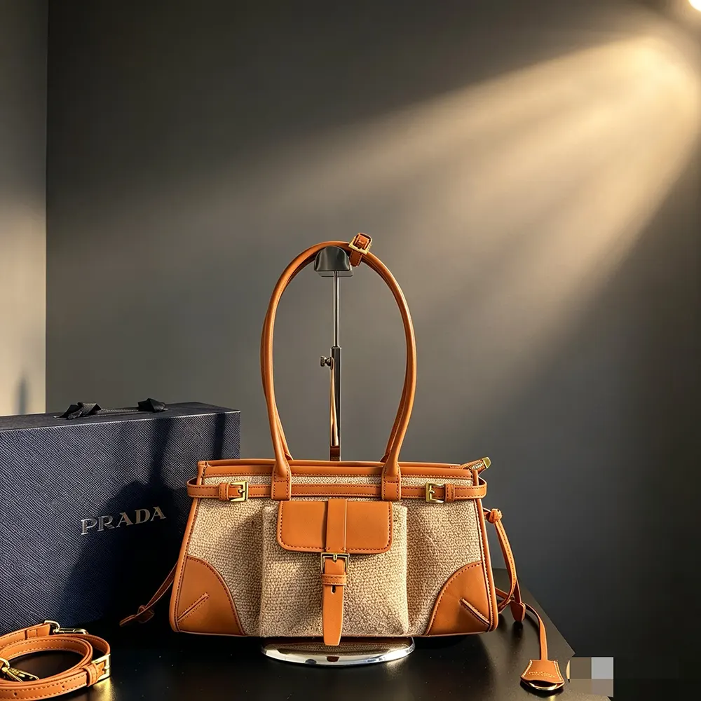 Close-up of gold-tone hardware on Prada Women Bonnie Medium Linen and Leather Handbag