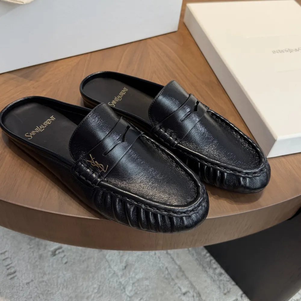 Overhead view showing black creased leather and slip-on silhouette