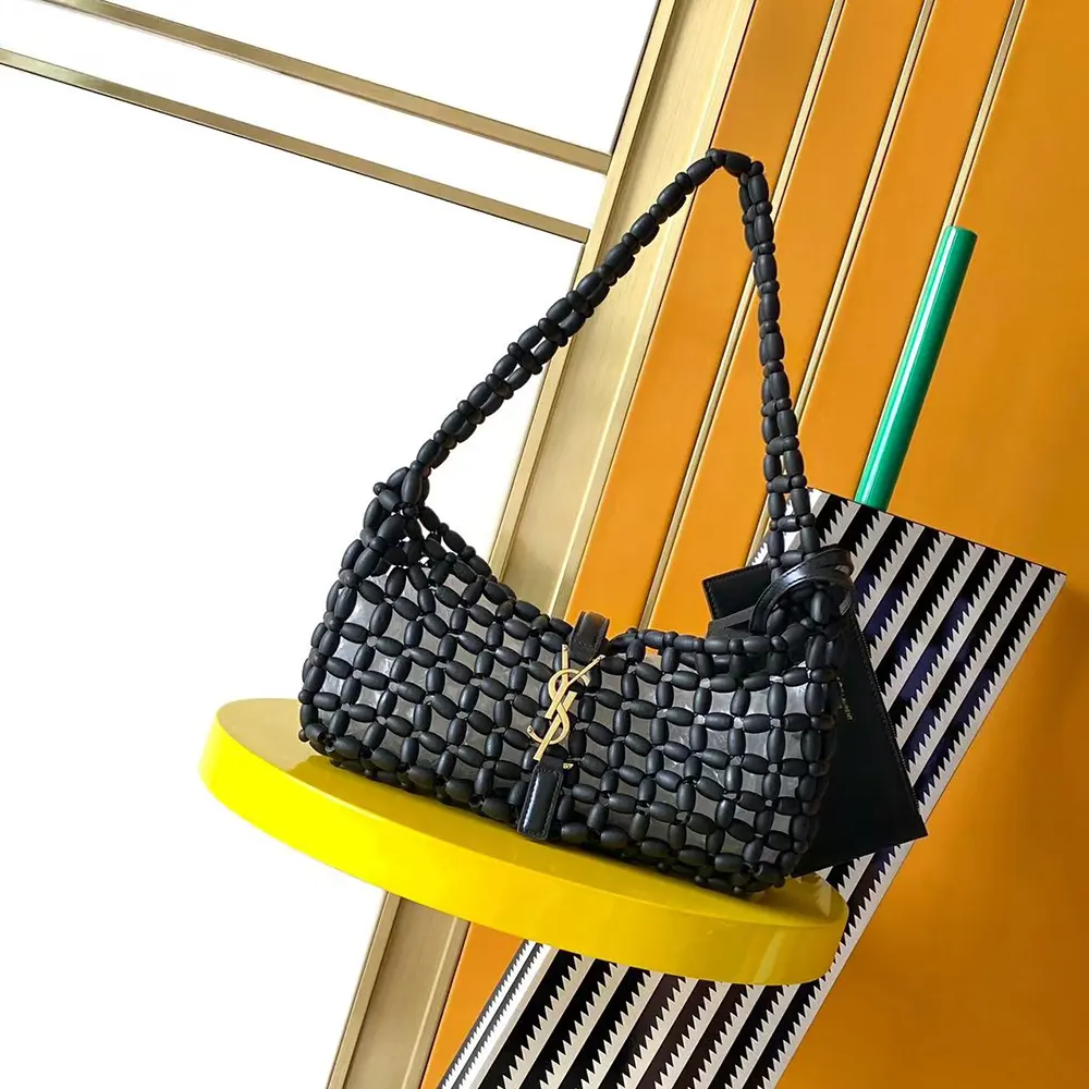 Close-up on magnetic snap and YSL logo hardware detail