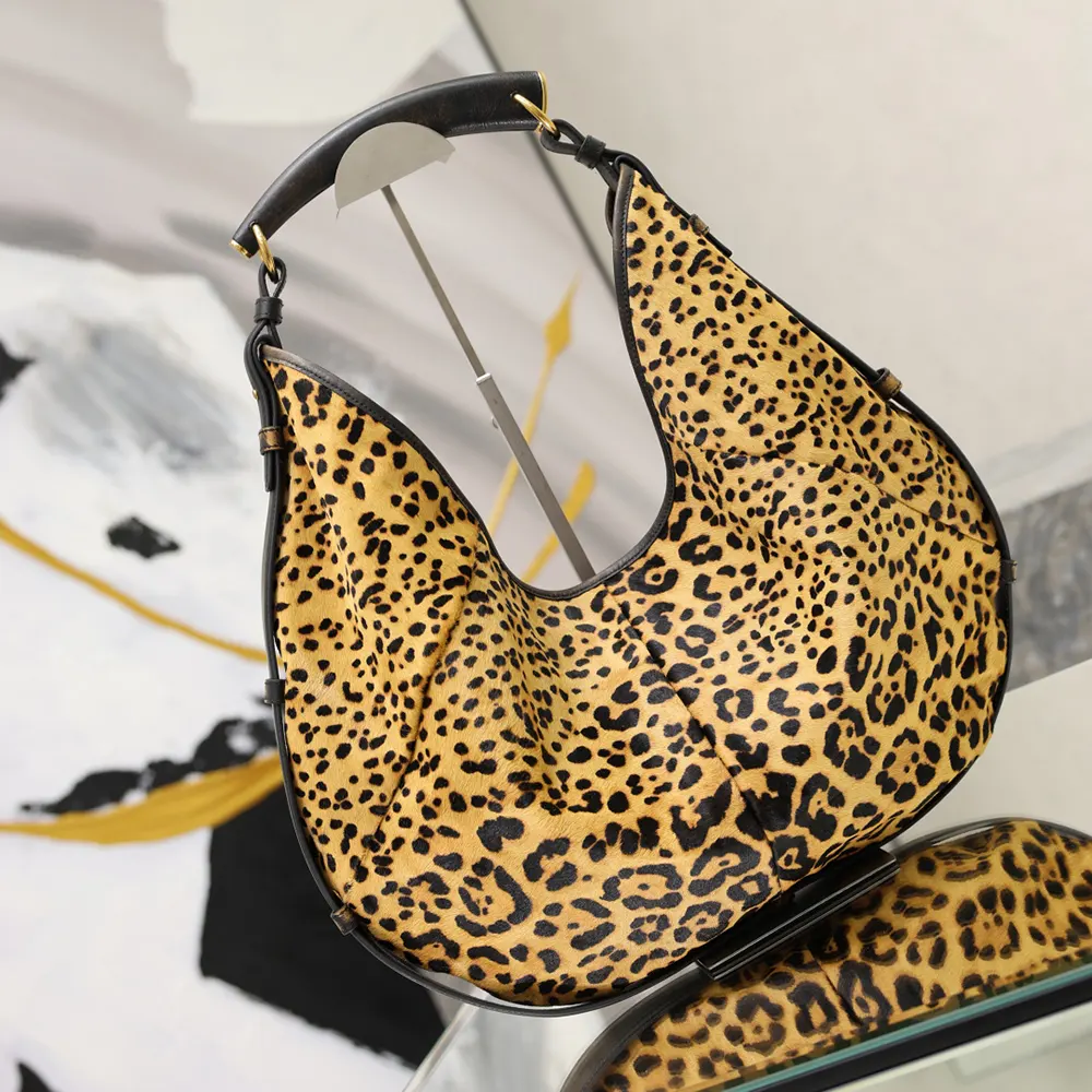 Side angle showing stitching and strap detail of Saint Laurent YSL Mombasa bag