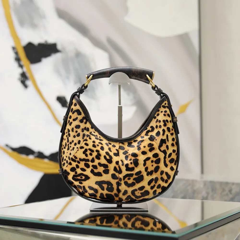 Side profile showing compact silhouette of Saint Laurent YSL Mombasa Small