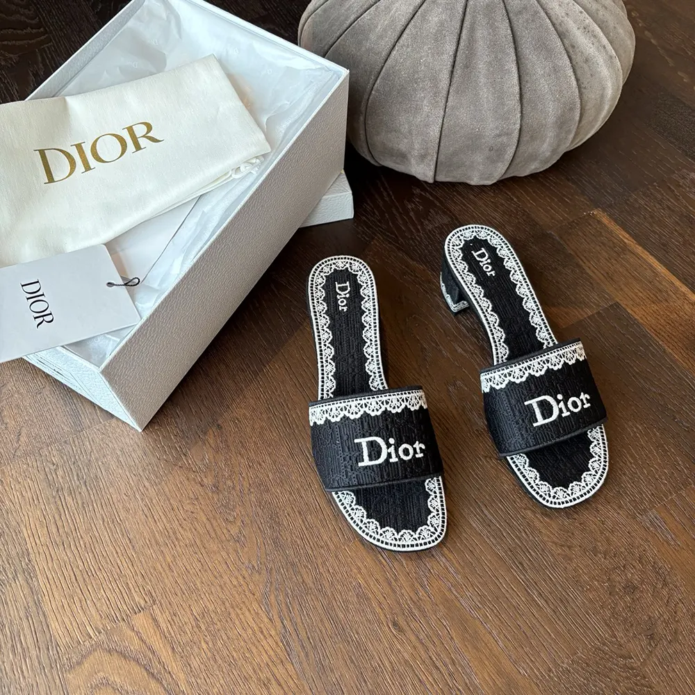 Close-up of Dior Oblique embroidery on navy cotton slide heel