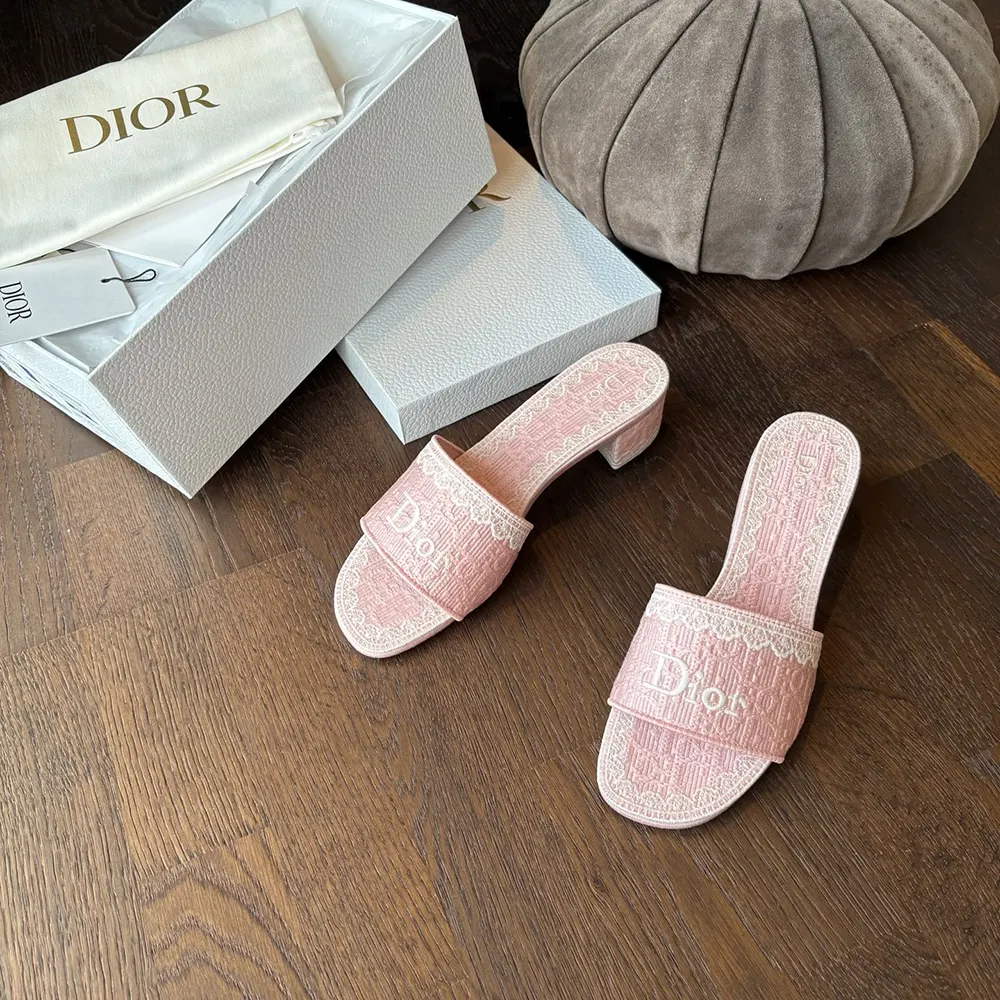 Side profile of pink Dioramour heeled slide with white lace details