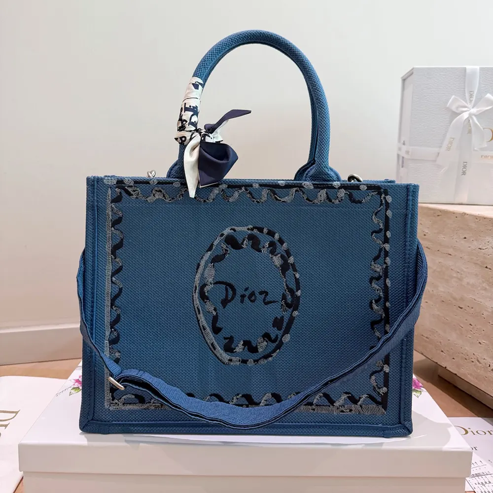 Close-up of blue-greige canvas and silver-tone hardware on Dior Women Dioriviera tote