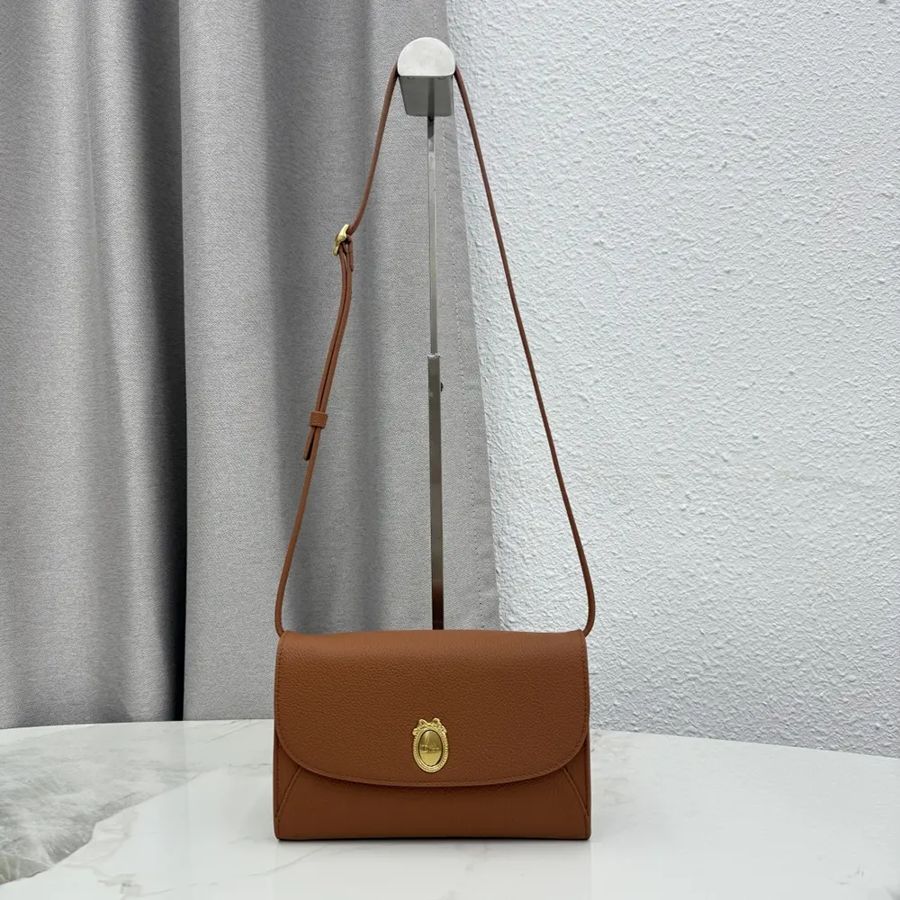 Close-up of gold medallion hardware on Dior Women Médaillon Envelope Pouch