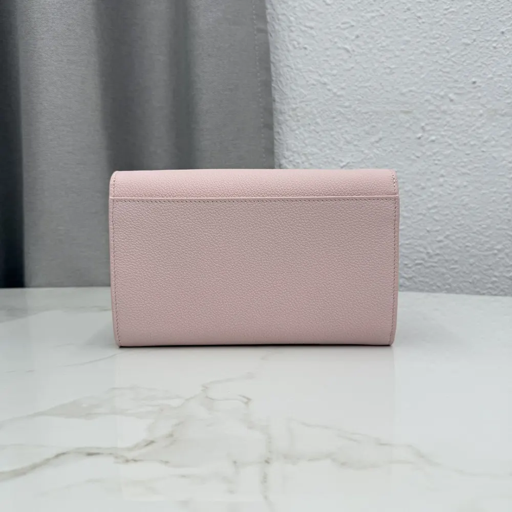 Side angle showing strap and grained leather texture on Dior pouch