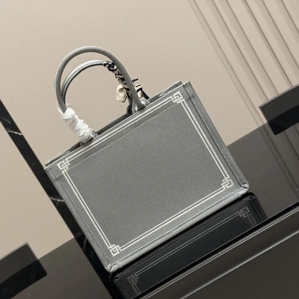 Side angle showing silver-tone hardware and strap detail on Dior medium shoulder bag