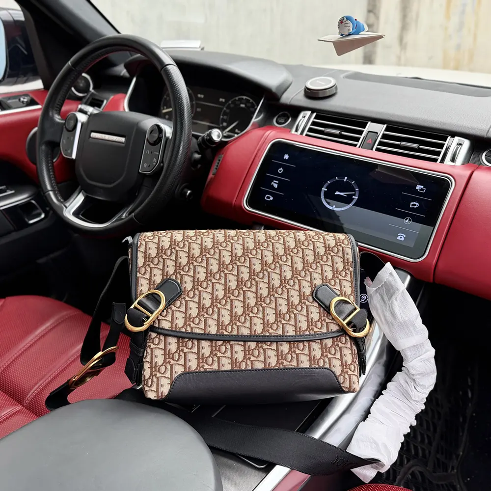 Close-up detail of brown Dior Oblique jacquard fabric and flap closure