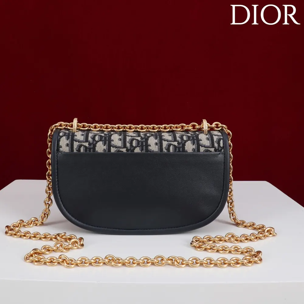 Side angle showing texture detail of Blue Dior Oblique jacquard on Dior Women Small Dior Médaillon Flap Bag