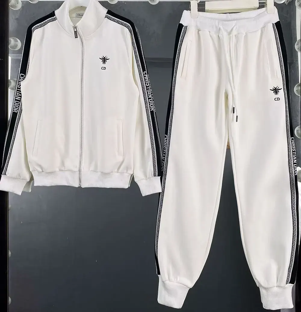 Close-up detail of iconic stripes and bee embroidery on tracksuit jacket