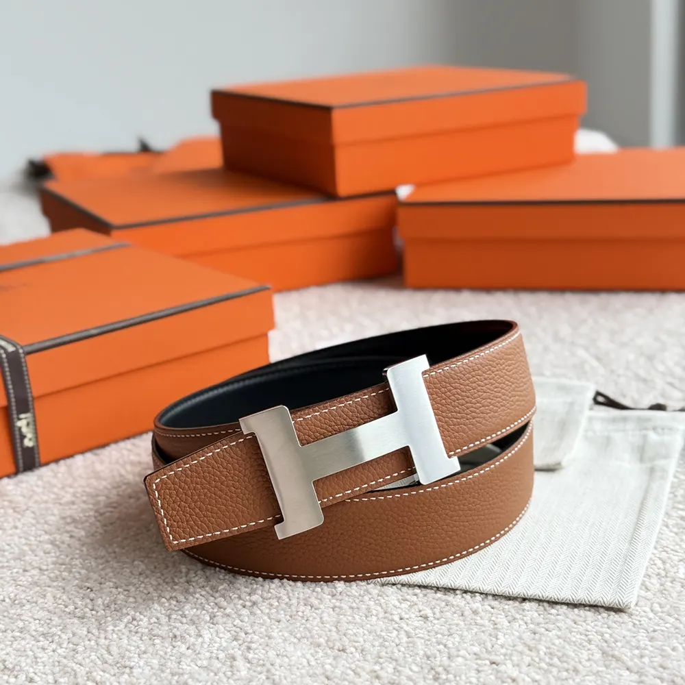 Side view showing reversible black leather strap of Hermes Unisex Constance Belt
