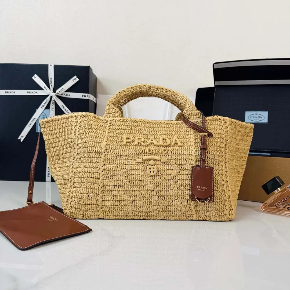 Close-up of leather handles and gold hardware on Prada crochet tote