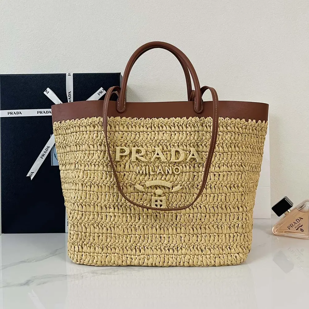 Close-up of gold-tone hardware on Prada Women Medium Crochet and Leather Tote Bag-Brown