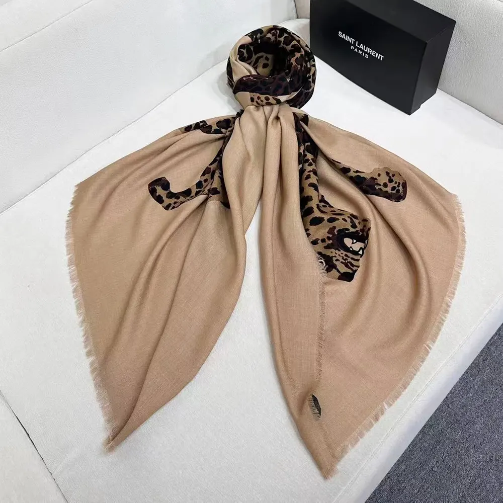 Close-up detail of iconic YSL Cassandre logo on wool twill scarf