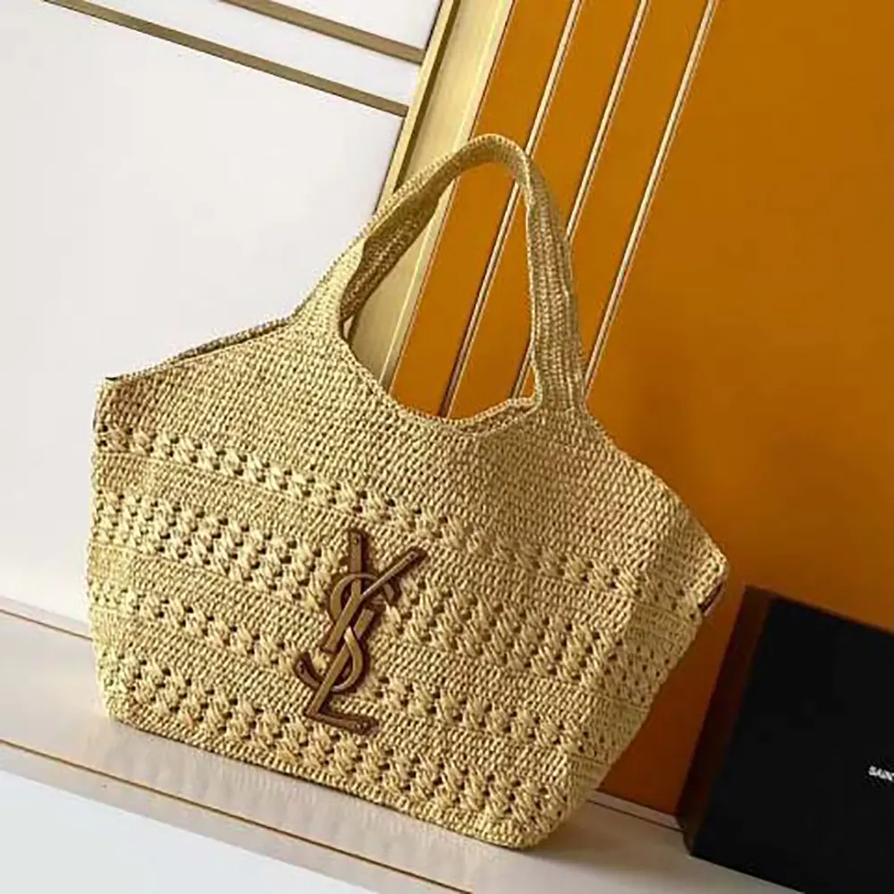 Close-up of gold YSL logo clasp on Icare Medium Raffia bag