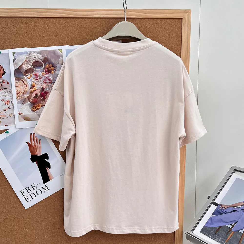 Side angle showing relaxed fit of Dior Women Oversized Embroidered Book Cover T-Shirt