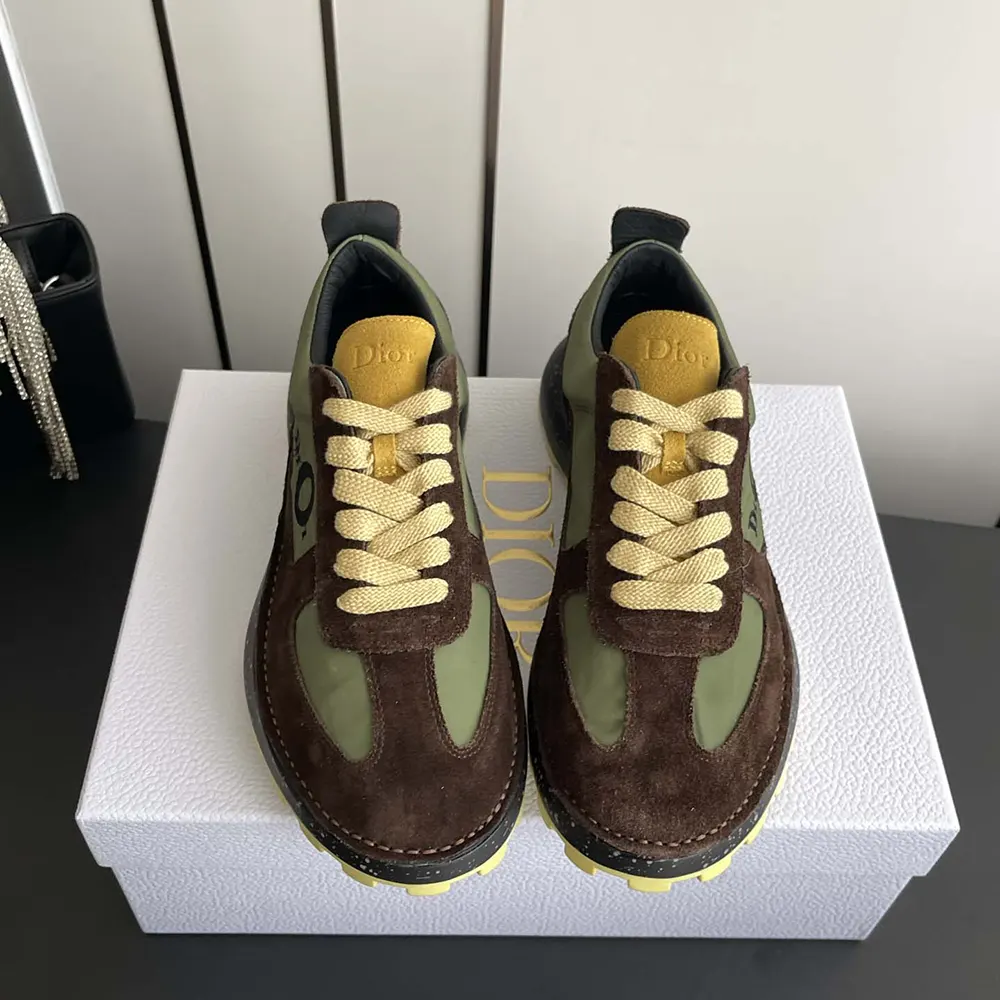 Top angle showing green technical fabric and yellow suede details