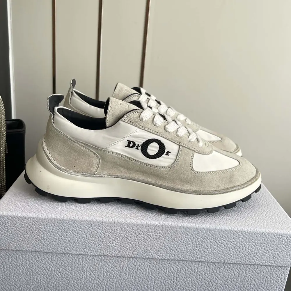 Close-up of gray suede calfskin and white technical fabric on Dior sneaker