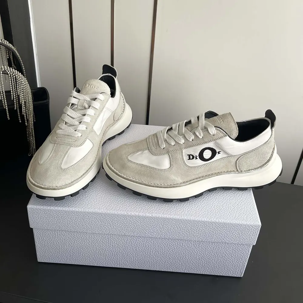 Top-down look at lacing and Dior embossed heel on unisex gray sneaker