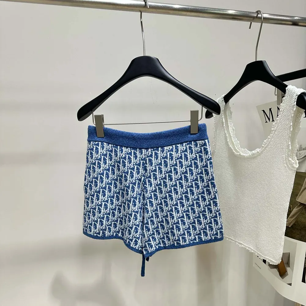 Side profile showing tailored silhouette of Dior Women Dioriviera Shorts in blue