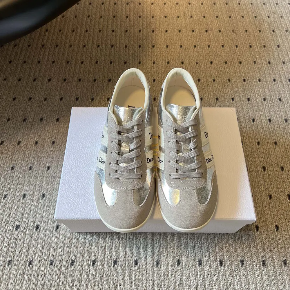 Close-up on silver-tone hardware and ribbon closure of Dior Ribbon Sneaker
