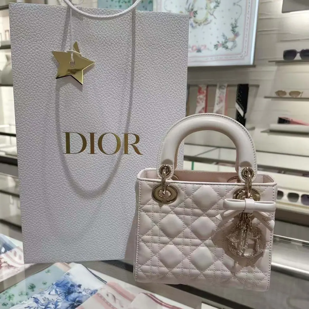 Close-up of silver-tone ‘D.I.O.R.’ charms on Mini Lady Dior Ballet Pink bag