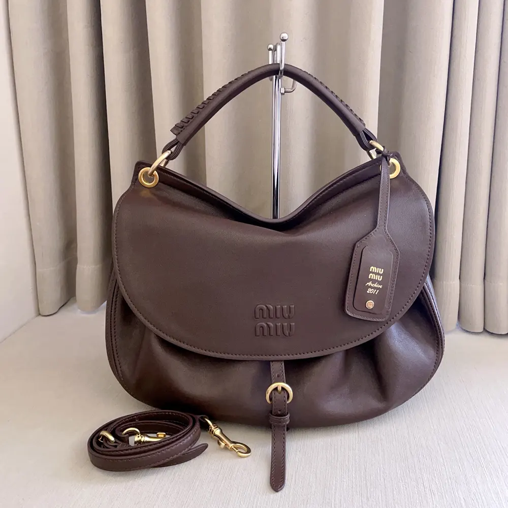 Close-up of gold-tone hardware and leather texture on Miu Miu Women Rendez-Vous Bag
