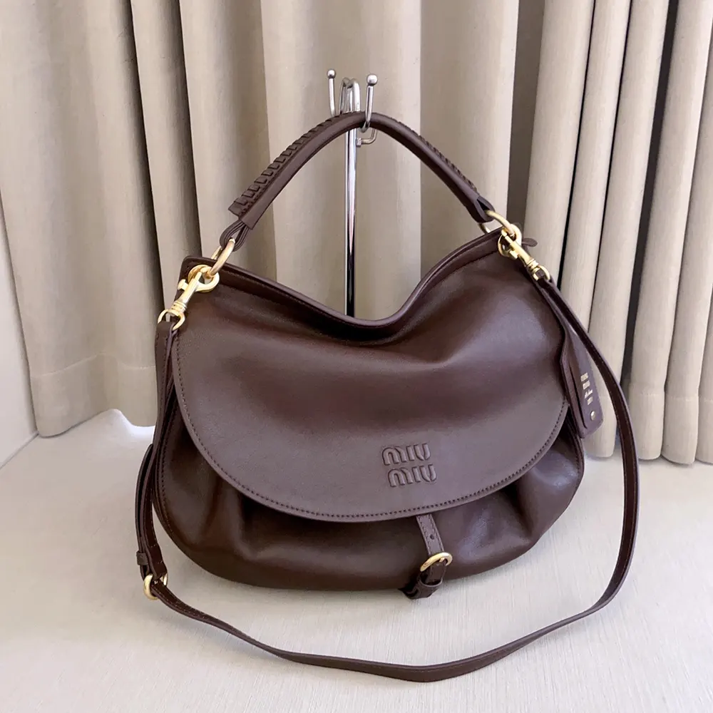 Side angle showing adjustable strap and silhouette of Miu Miu Women Rendez-Vous Bag