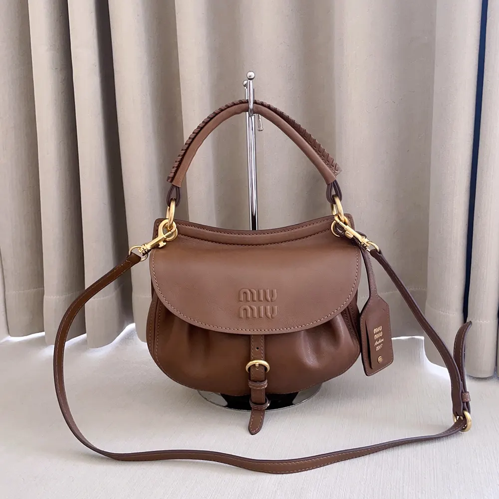 Close-up of gold hardware details on Miu Miu Women Rendez-Vous Nappa Leather Bag Oak