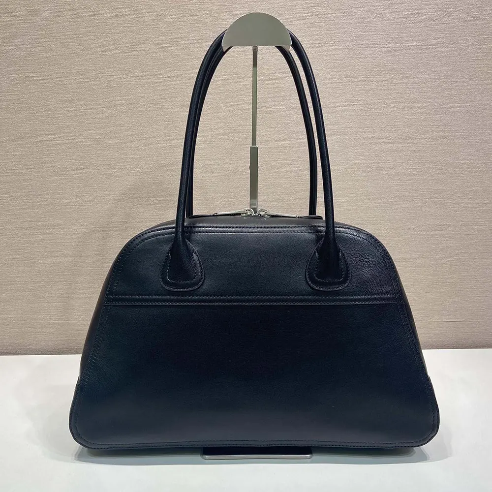 Side angle of Miu Miu Women Vivant Leather Bag Black displaying adjustable shoulder strap