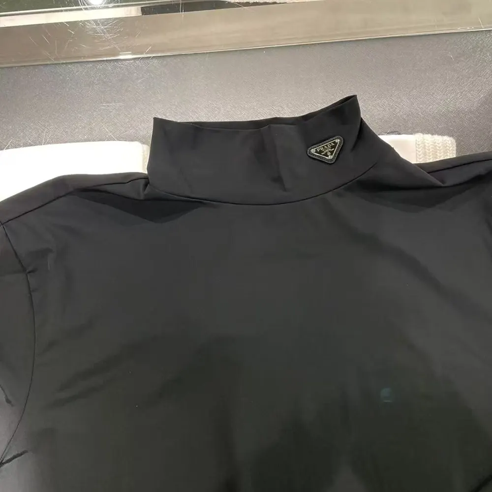 Side angle showing slim fit of Prada Men Tech Jersey Mock-Neck Sweater