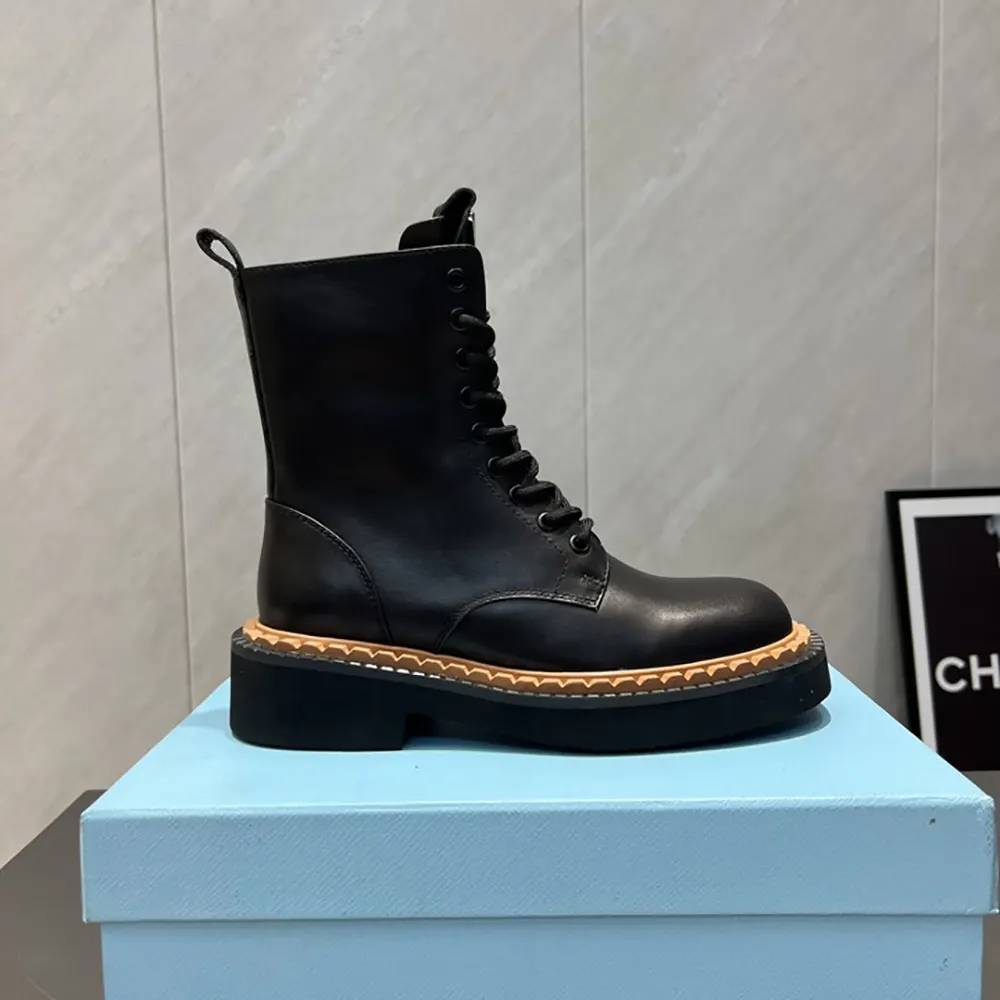 Close-up on zip and Prada hardware on black leather combat boots