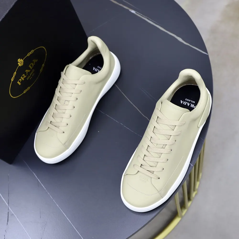 Rear view showing embossed Prada logo on heel of court sneakers