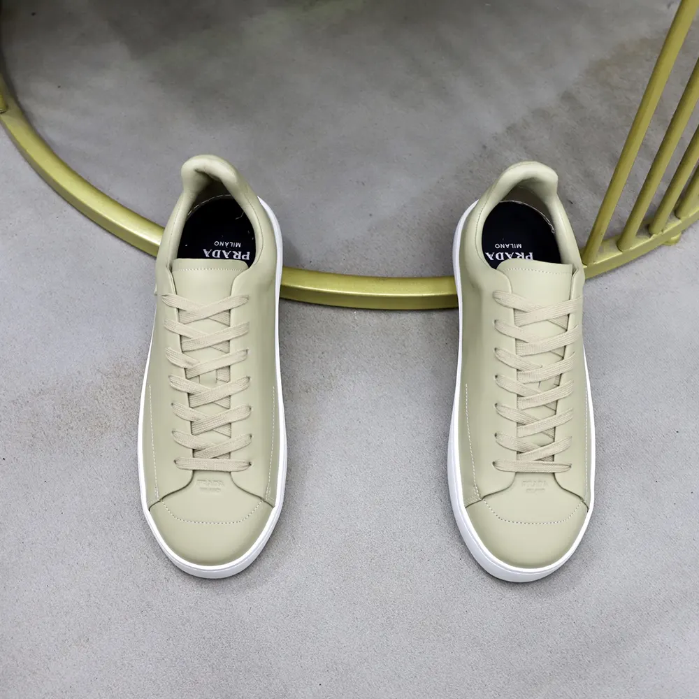 Close-up on lace-up closure and leather texture of Prada sneakers