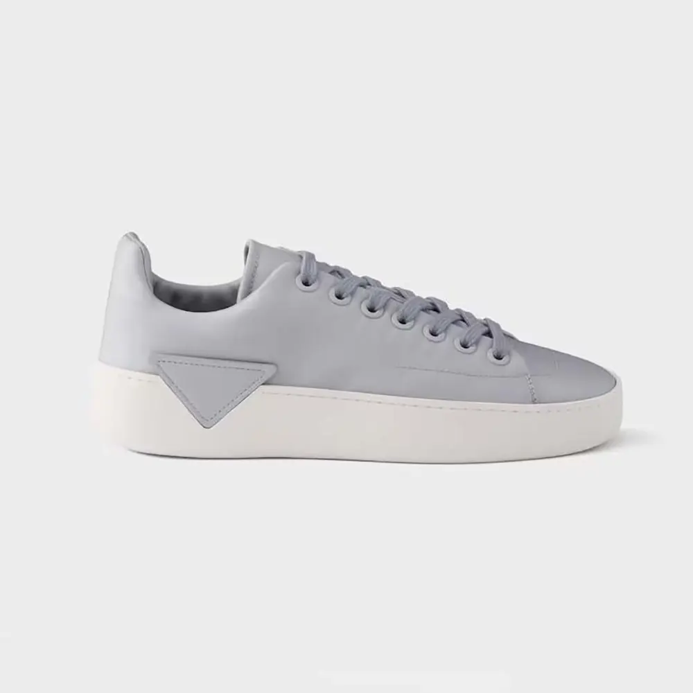 Side view of Prada Unisex Court Leather Sneakers-Pearl Gray in natural light