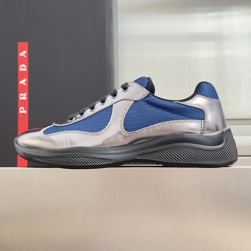 Close-up of navy patent leather and technical fabric detail on Prada America’S Cup Sneakers