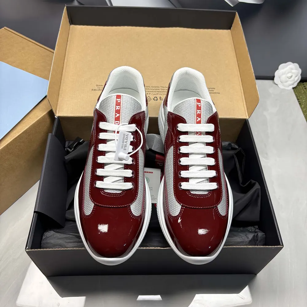 Close-up of burgundy patent leather and technical fabric on Prada America’S Cup Sneakers