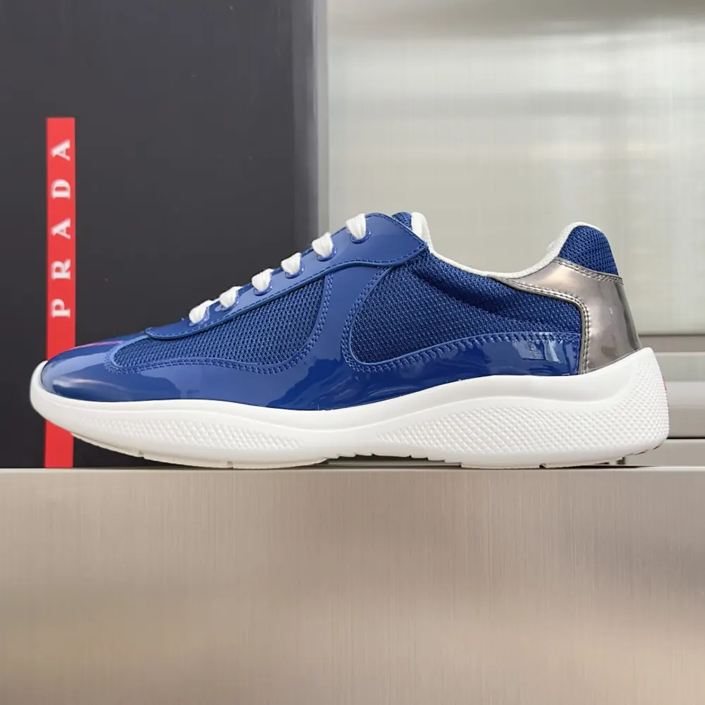 Close-up of navy patent leather and technical fabric on Prada America’S Cup sneakers