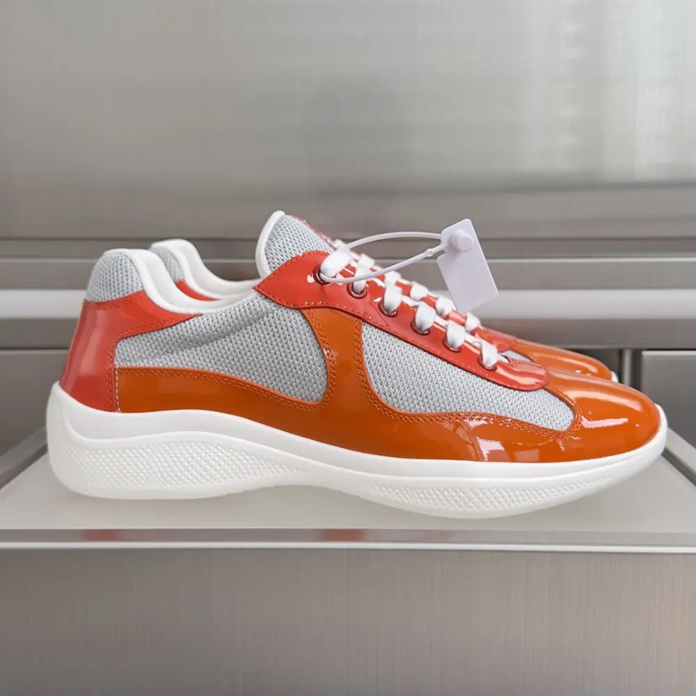 Close-up of vibrant orange patent leather on Prada America’S Cup sneakers