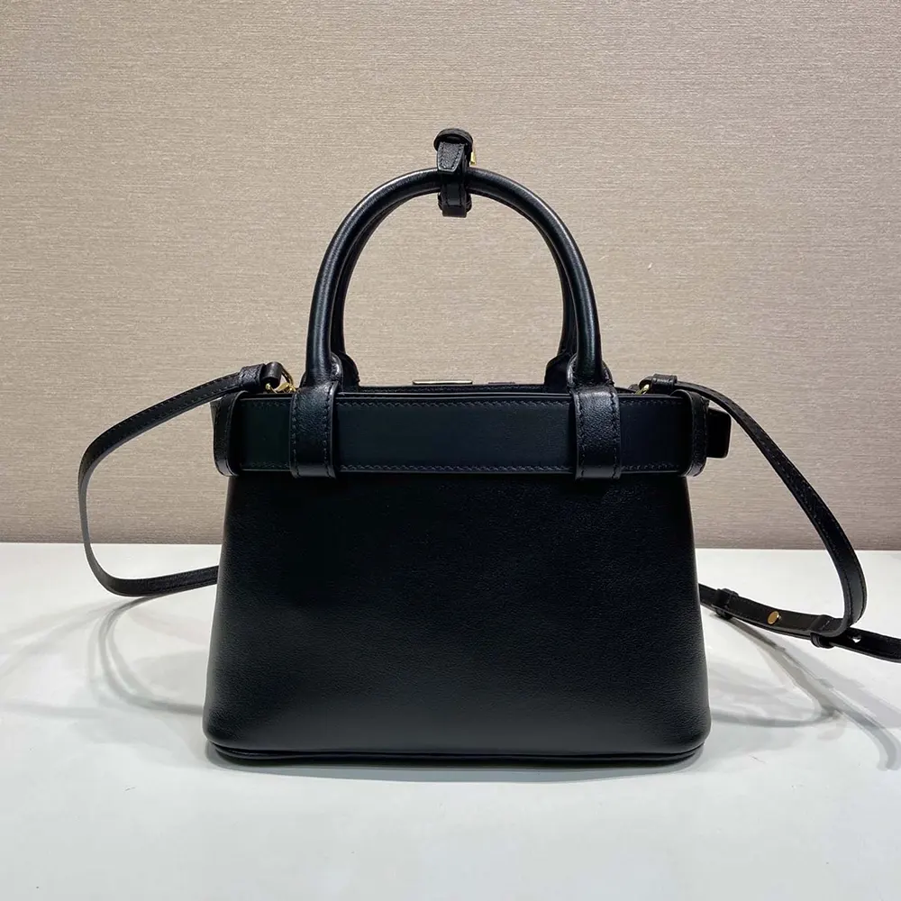 Side angle showing strap and silhouette of Prada Wome Buckle Small Leather Bag