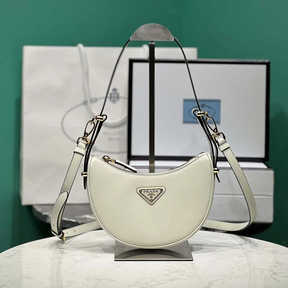 Close-up of silver-tone clasp on Prada Women Arqué Mini Leather Shoulder Bag-White