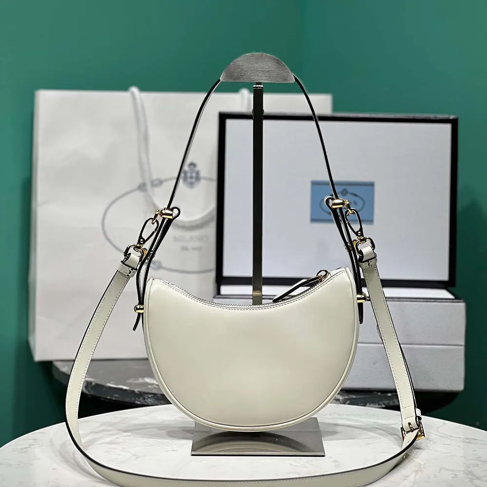 Side angle showing curved silhouette of Prada Women Arqué Mini Leather Shoulder Bag-White
