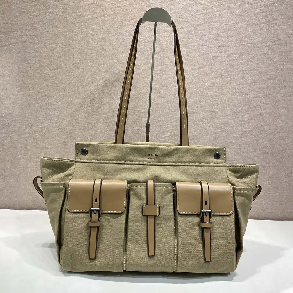 Close-up of Prada logo and silver hardware on the natural canvas tote bag