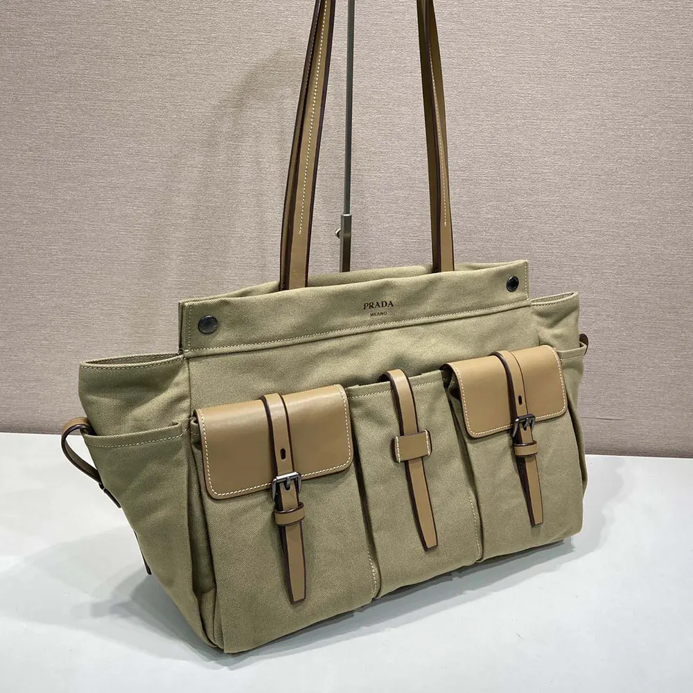 Side angle showing structured silhouette of Prada Women Route Canvas and Leather Tote Bag