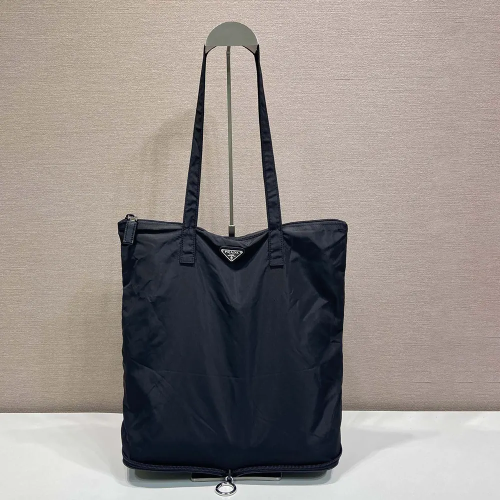Side angle showing structured silhouette of Prada Re-Nylon tote bag