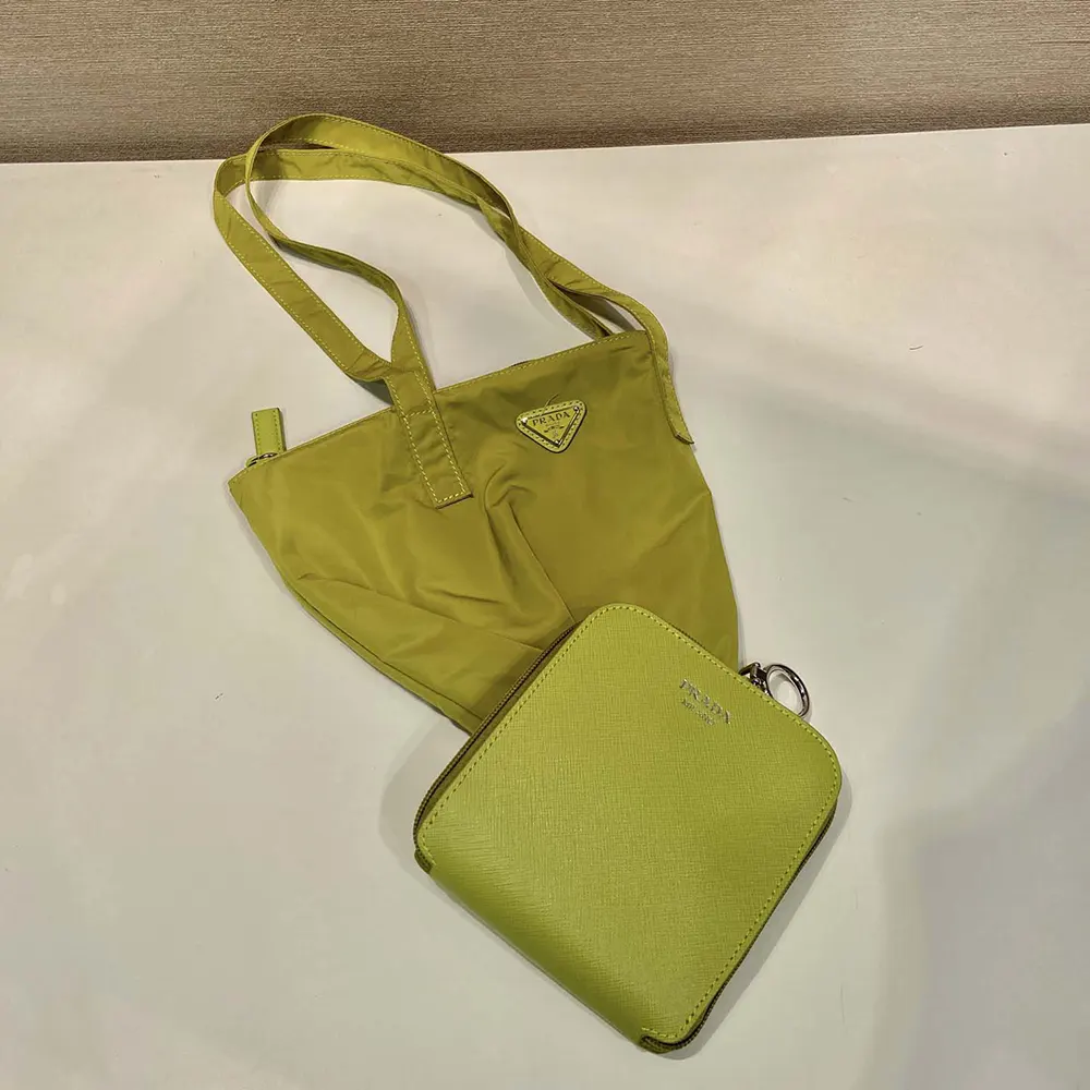 Close-up of leather pendant and silver hardware on Prada tote bag