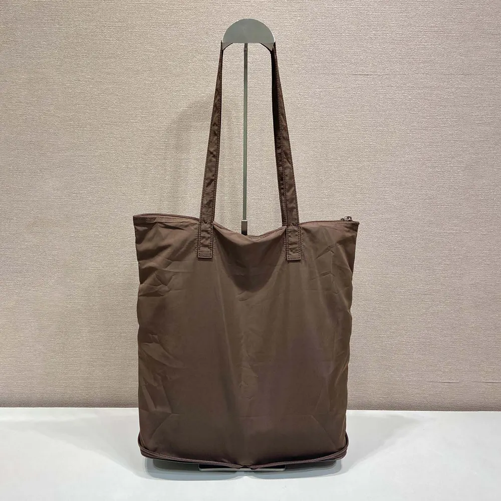 Side angle showing coffee colour and structured silhouette of Prada tote bag